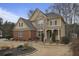 Charming two-story home featuring a mix of stone and brick facade, landscaped front yard, and inviting front porch at 1554 Sage Ridge Dr, Marietta, GA 30064