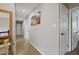 Hallway with hardwood flooring and artwork, leading to multiple rooms in the home at 1554 Sage Ridge Dr, Marietta, GA 30064