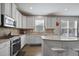 Bright kitchen with stainless steel appliances, center island, granite countertops, and warm backsplash at 1554 Sage Ridge Dr, Marietta, GA 30064