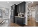 Open kitchen with dark cabinetry, stainless steel refrigerator, and hardwood flooring at 1554 Sage Ridge Dr, Marietta, GA 30064