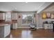 Charming kitchenette featuring ample natural light, tile backsplash, granite countertops, and wood floors at 1554 Sage Ridge Dr, Marietta, GA 30064