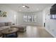 Bright living room with hardwood floors, recessed lighting, and a view of the wooded backyard through the windows at 1554 Sage Ridge Dr, Marietta, GA 30064