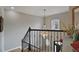 Elegant staircase with a black iron railing and a chandelier, leading to the upper level at 1554 Sage Ridge Dr, Marietta, GA 30064