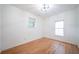 Cozy bedroom with hardwood floors, neutral walls, and natural light with a view of the outdoors at 2426 Vivian Cir, Decatur, GA 30030