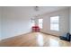 Sun-filled bedroom with hardwood floors, and a pop of color from a small red desk at 2426 Vivian Cir, Decatur, GA 30030