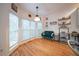 Bright breakfast nook features hardwood floors, a modern light fixture, and many windows for natural light at 2426 Vivian Cir, Decatur, GA 30030