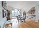 Bright dining area with hardwood floors, a modern light fixture, and a large window offering natural light at 2426 Vivian Cir, Decatur, GA 30030