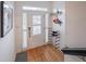 Bright entryway featuring light wood floors, white walls, a white door, and organized storage and decor at 2426 Vivian Cir, Decatur, GA 30030