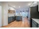 Bright kitchen featuring stainless steel appliances, two-tone cabinets, hardwood floors, and floating shelves at 2426 Vivian Cir, Decatur, GA 30030