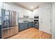 Well-appointed kitchen featuring stainless steel appliances, hardwood floors, two-tone cabinets, and a gas cooktop at 2426 Vivian Cir, Decatur, GA 30030