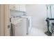 Bright laundry room with washer, dryer, white cabinets and white flooring at 2426 Vivian Cir, Decatur, GA 30030