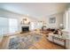 Inviting living room featuring a fireplace, hardwood floors, large windows, and a comfortable seating area at 2426 Vivian Cir, Decatur, GA 30030