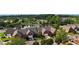 Wide aerial shot showcasing the community's layout, with homes arranged around a pond and green spaces at 352 Lauren Ln, Woodstock, GA 30188