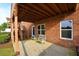 Backyard patio area with chairs and an exterior view of the brick house at 352 Lauren Ln, Woodstock, GA 30188