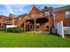 View of backyard featuring grass, patio, deck, and brick exterior of home at 352 Lauren Ln, Woodstock, GA 30188