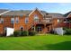 Backyard featuring a grass lawn, brick home exterior, patio, and a deck at 352 Lauren Ln, Woodstock, GA 30188