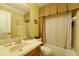 Cozy bathroom with a classic vanity, framed mirror, and shower-tub combo perfect for relaxation at 352 Lauren Ln, Woodstock, GA 30188