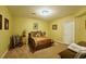 Bedroom featuring carpet floors, a bed with brown and gold bedding, and warm lighting at 352 Lauren Ln, Woodstock, GA 30188