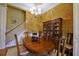 Inviting dining room with a large table, elegant chandelier, and classic china cabinet at 352 Lauren Ln, Woodstock, GA 30188