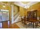 Formal dining room with elegant chandelier, china cabinet, and staircase at 352 Lauren Ln, Woodstock, GA 30188