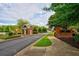 A landscaped entrance with brick signage and a guardhouse welcomes you to the Claremore Lake community at 352 Lauren Ln, Woodstock, GA 30188