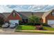 Exterior featuring a brick facade, well-maintained lawn, and a driveway with parking for two cars at 352 Lauren Ln, Woodstock, GA 30188