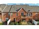 Exterior of the home features brick facade, roofline and a walkout patio with a stairway leading to a wooden deck at 352 Lauren Ln, Woodstock, GA 30188