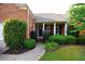 A walkway leads to the front entrance, framed by columns and surrounded by lush landscaping at 352 Lauren Ln, Woodstock, GA 30188