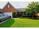 Charming brick home with well-manicured front lawn and driveway; an inviting facade at 352 Lauren Ln, Woodstock, GA 30188