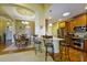 A well-lit kitchen and dining area featuring wood floors, granite countertops, and stainless steel appliances at 352 Lauren Ln, Woodstock, GA 30188