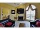 A cozy living room features a fireplace, large arched window, and plush black leather sofas at 352 Lauren Ln, Woodstock, GA 30188