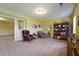 Cozy living area with neutral carpeting, a bookshelf, and comfortable seating at 352 Lauren Ln, Woodstock, GA 30188