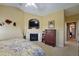 Bright main bedroom featuring a fireplace and view to the entry of the home at 352 Lauren Ln, Woodstock, GA 30188