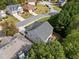 A high angle captures a lovely home with a gray roof, green lawn, and mature trees in a suburban neighborhood setting at 3865 Brookhollow Dr, Douglasville, GA 30135