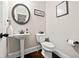 Elegant powder room features a pedestal sink, modern fixtures, and stylish decor at 3865 Brookhollow Dr, Douglasville, GA 30135