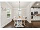 Cozy dining room features a wooden table, white chairs, and an abundance of natural light at 3865 Brookhollow Dr, Douglasville, GA 30135