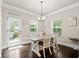 Dining room with a white table and chairs with natural light from windows and exit to patio at 3865 Brookhollow Dr, Douglasville, GA 30135