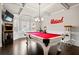 Game room featuring a red pool table, arcade game, and bright natural light from surrounding windows at 3865 Brookhollow Dr, Douglasville, GA 30135