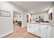 Bright kitchen with white cabinets, granite countertops, and views into the living room at 3865 Brookhollow Dr, Douglasville, GA 30135