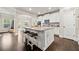 Bright kitchen with white cabinets, granite countertops, and a center island featuring stylish bar stools at 3865 Brookhollow Dr, Douglasville, GA 30135