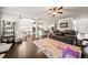 Open concept living room with hardwood floors, a fireplace, and an adjacent kitchen and dining area at 3865 Brookhollow Dr, Douglasville, GA 30135