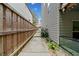 Narrow side yard features a concrete path between the house and a tall wood fence at 3865 Brookhollow Dr, Douglasville, GA 30135