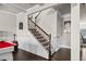 View of the staircase with dark wood floors, white trim, and black iron spindles at 3865 Brookhollow Dr, Douglasville, GA 30135