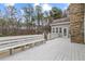 Spacious, bright deck with stone fireplace and built in bench seating overlooking lush backyard at 398 Picketts Xing, Acworth, GA 30101