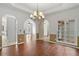 Elegant dining room with hardwood floors, chandelier, and large windows overlooking the exterior at 398 Picketts Xing, Acworth, GA 30101