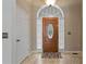 Welcoming foyer with travertine tile flooring, decorative front door, and plenty of natural light at 398 Picketts Xing, Acworth, GA 30101