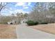 Exterior view of the front of the house with long driveway at 398 Picketts Xing, Acworth, GA 30101