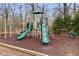 Community playground with slides, climbing bars, and wood chip ground cover at 4037 Mcpherson Dr, Acworth, GA 30101