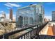 Rooftop view of city with glass and steel buildings, blue sky, and distant traffic at 115 W Peachtree Nw # 405, Atlanta, GA 30313