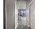 Hallway view into the condo's living space with large window and concrete ceilings at 115 W Peachtree Nw # 405, Atlanta, GA 30313